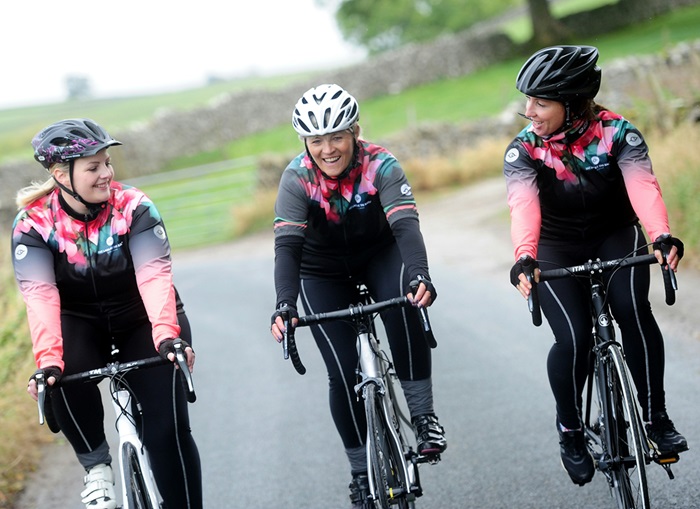 Three women riding in the countryside